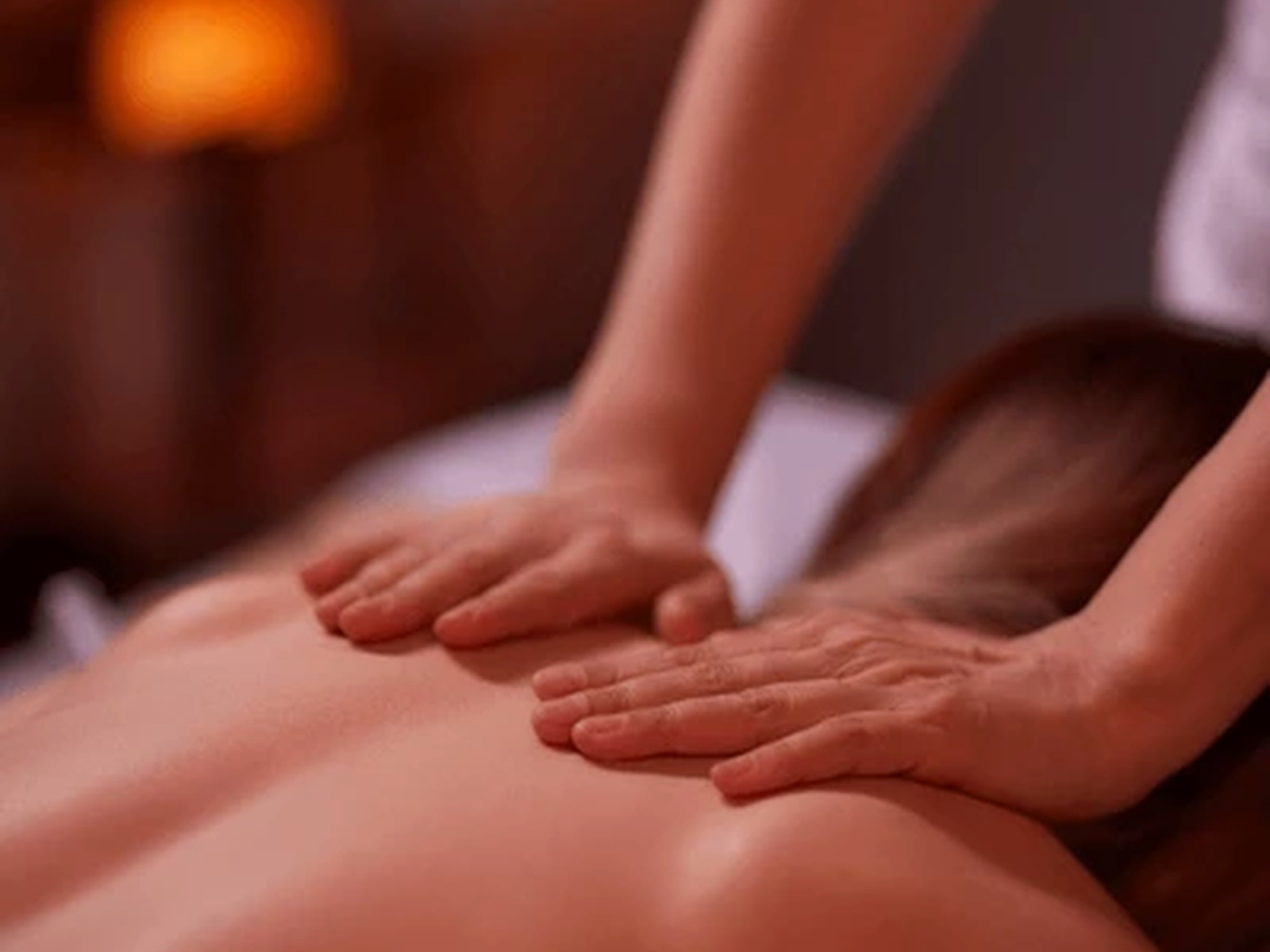 Back massage with warm ambient lighting